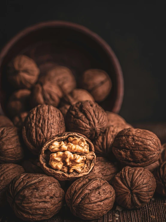 a pile of walnuts sitting on top of a wooden table