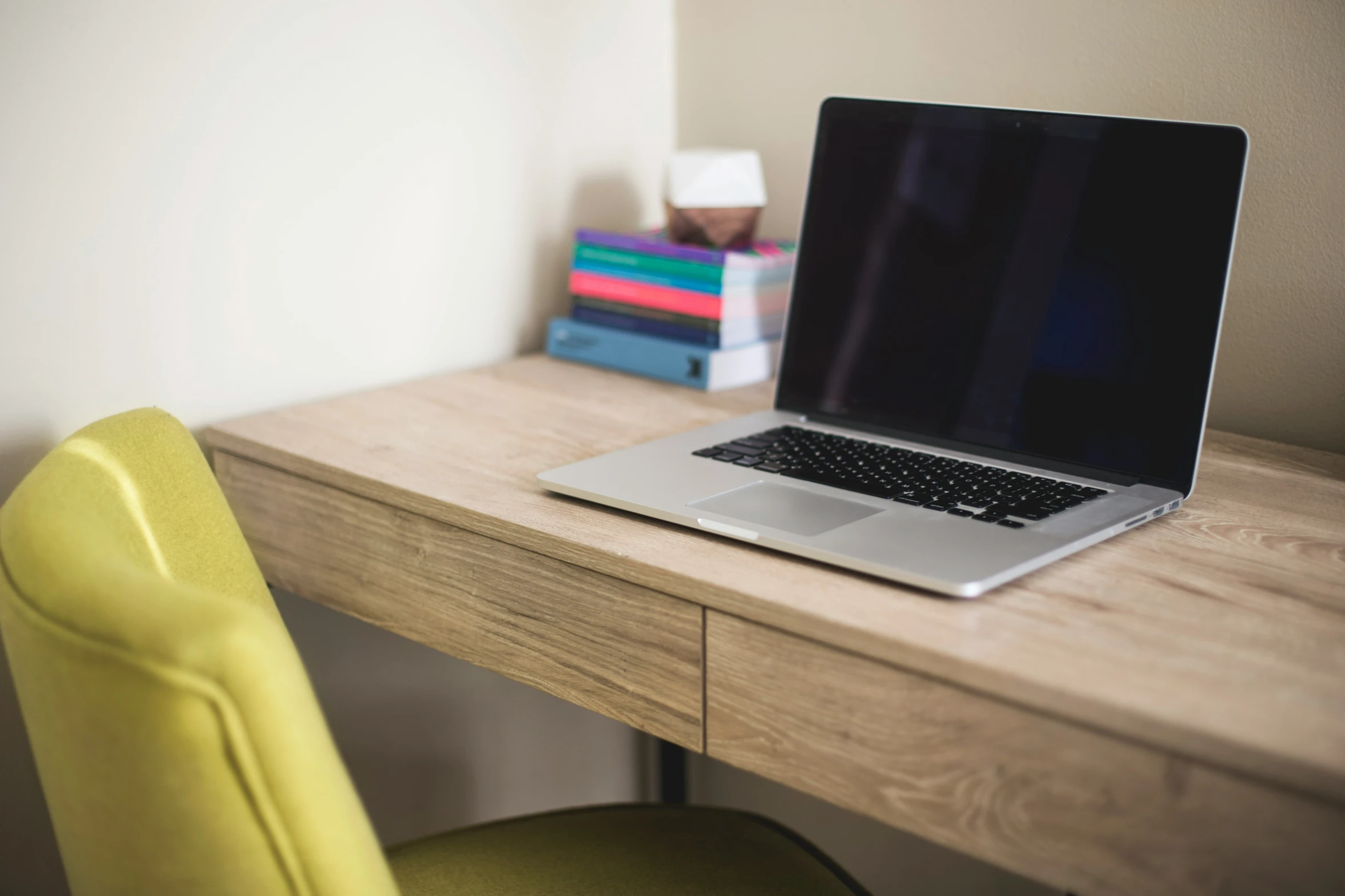 a desk with a laptop on top of it