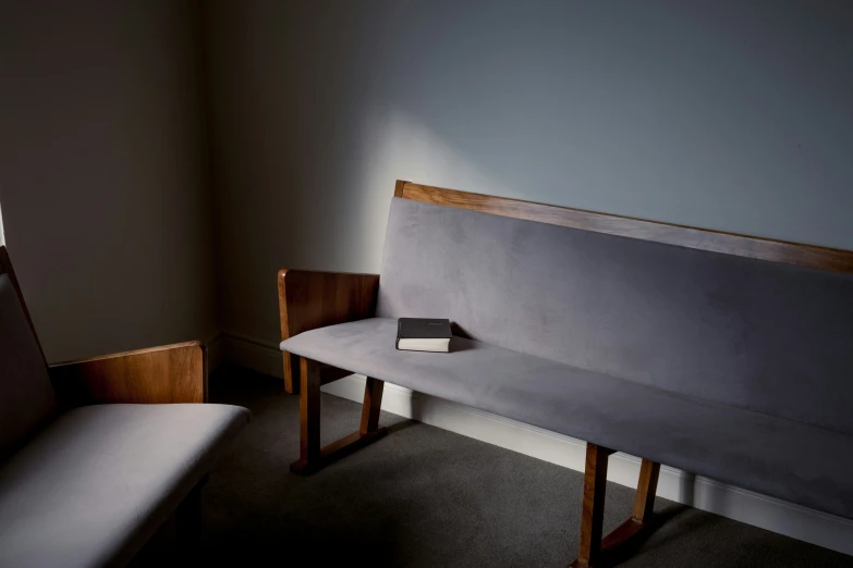 a small book is on the back of the bench