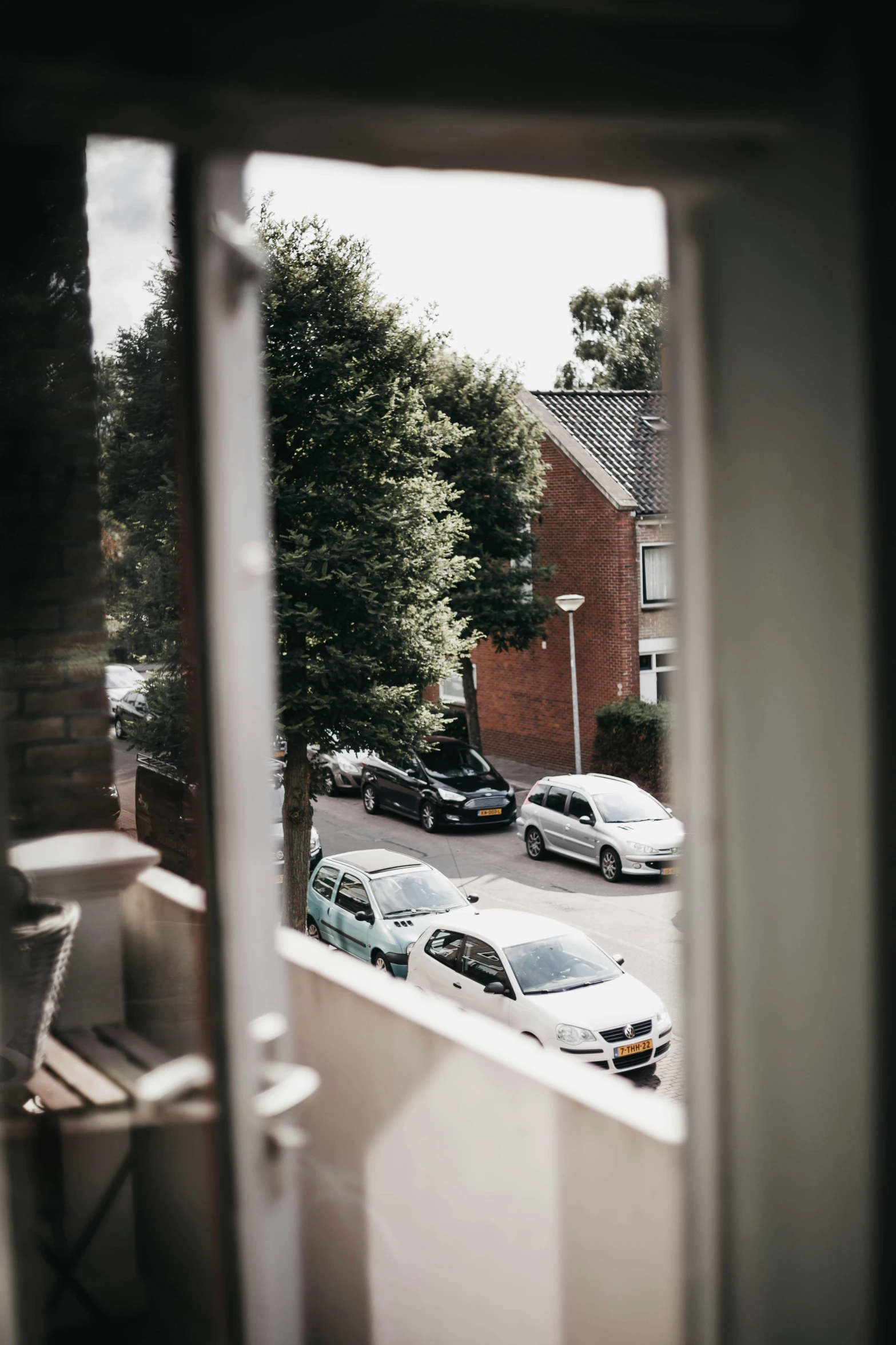 a view of a parking lot from inside a house