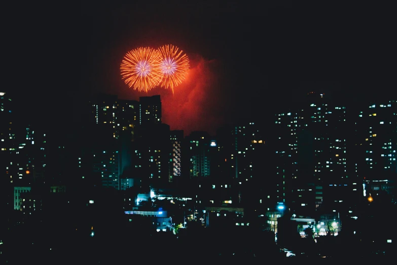 there is a fireworks on the night sky over the city