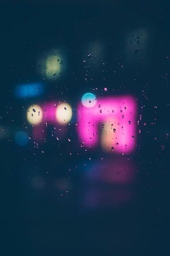 view through a wet window showing city lights and rain