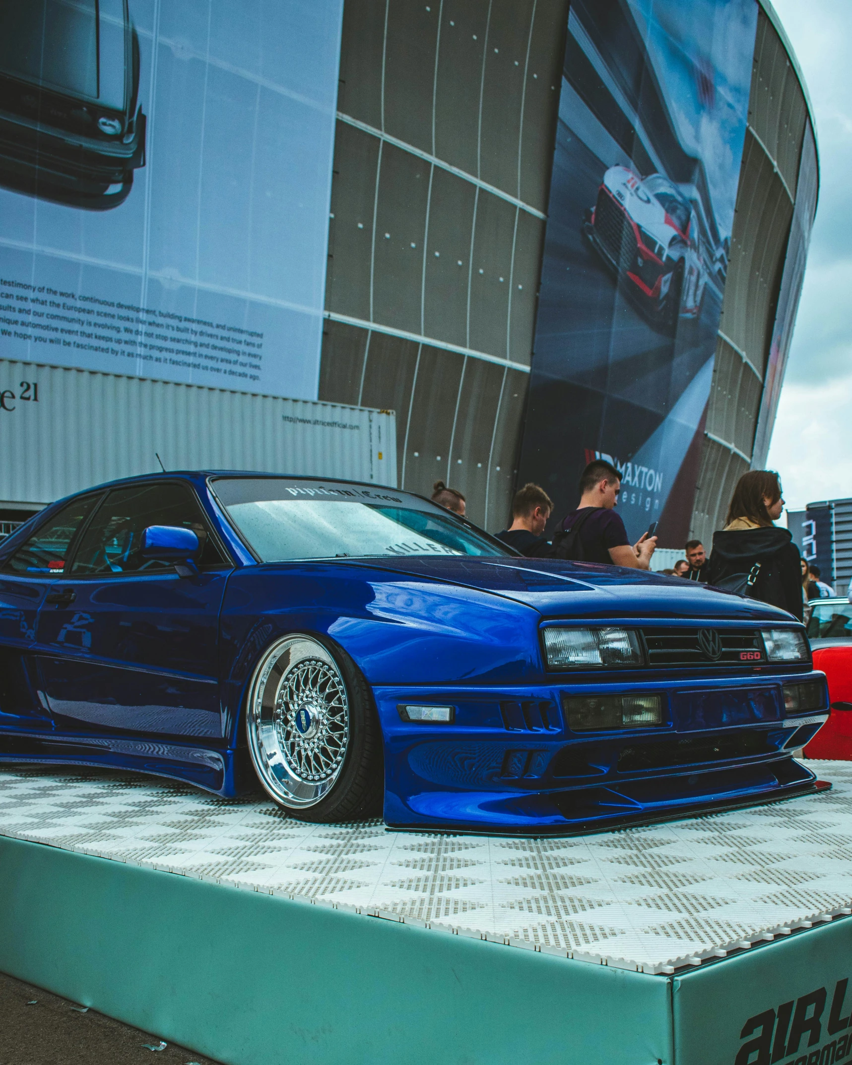 a blue car parked on top of a green shelf