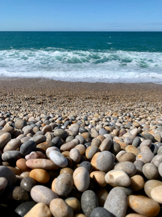 a beach that has rocks in the sand on it