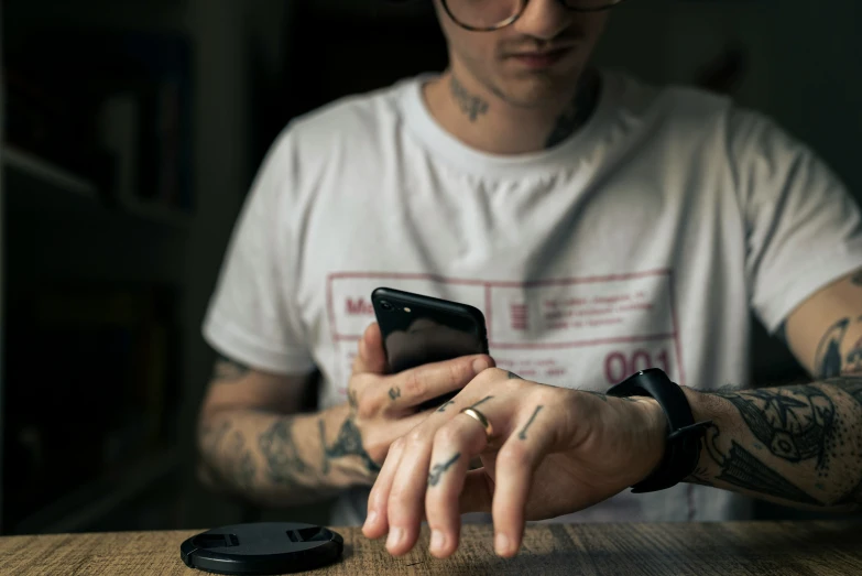 a man using his phone on the table