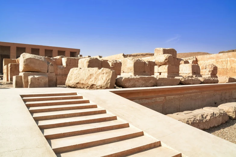 a stone building with steps leading to the upper part