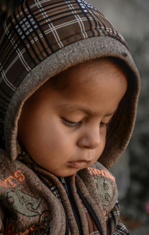 a small child wearing a hat on top of his head