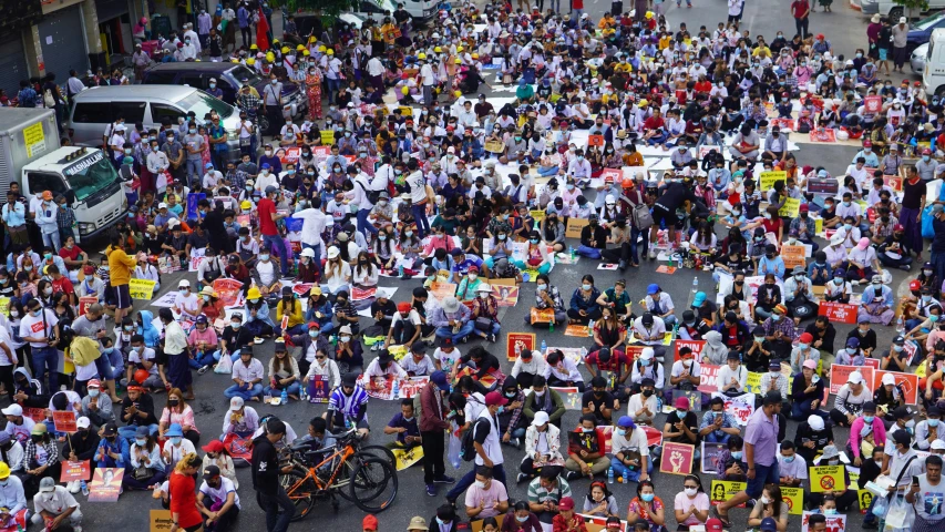 a large group of people stand on the road