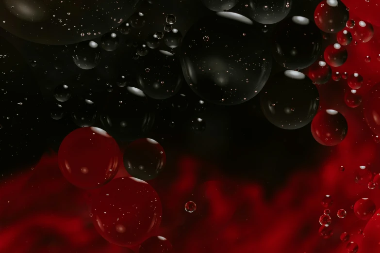 black and red liquid pouring onto water and bubbles