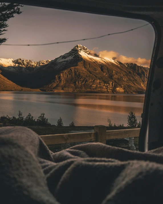 a po taken out a vehicle window of a lake in the mountains