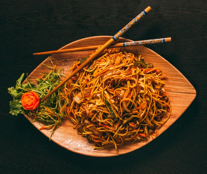 a plate with noodles and some dipping sticks