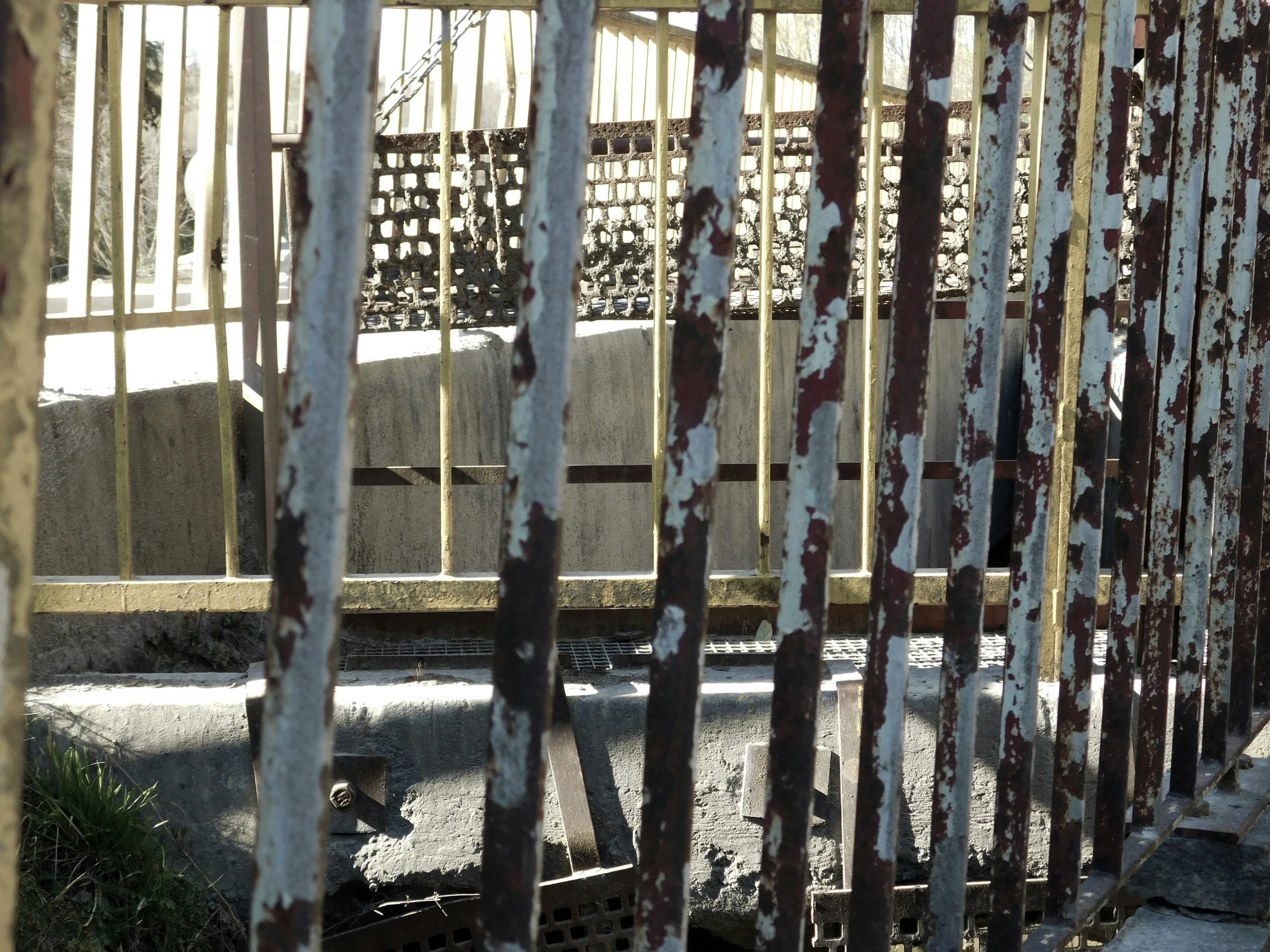 there are rusted metal bars in the grate of an old building