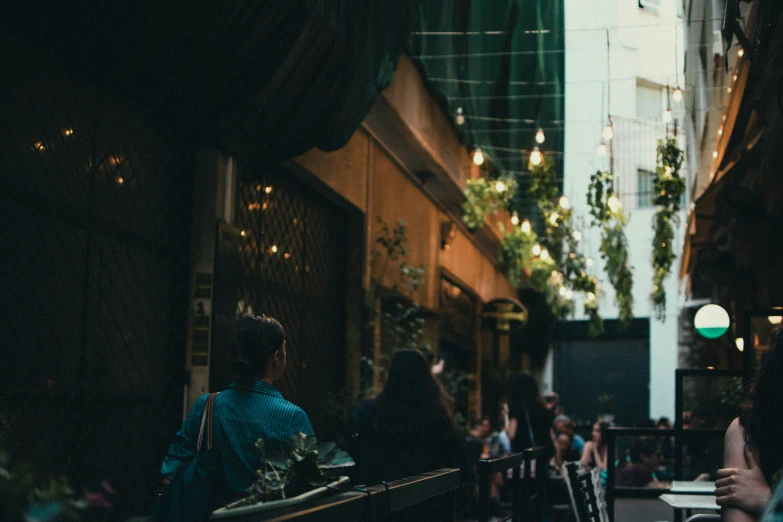 a couple sit on a bench together in a dark alley way