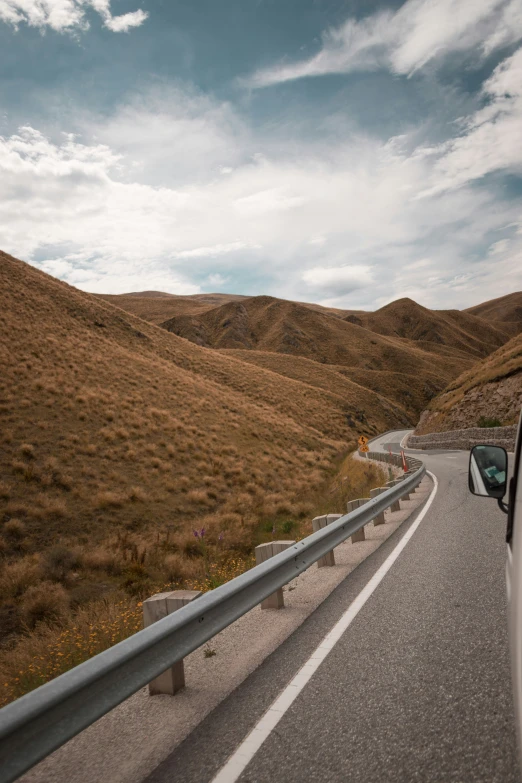 view of an image from the back of a car of a winding road