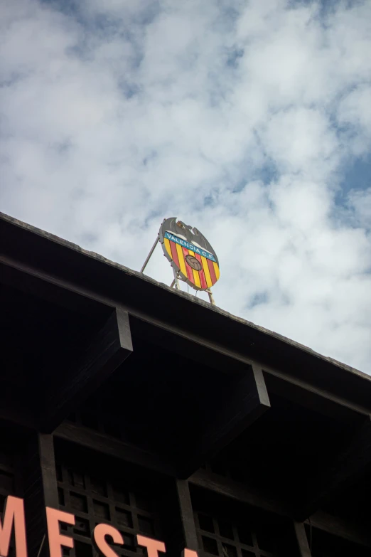 the crest of a  air balloon in a cloudy blue sky