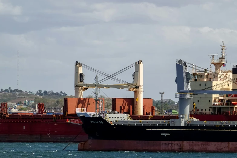 a boat with cargo on it next to an ocean