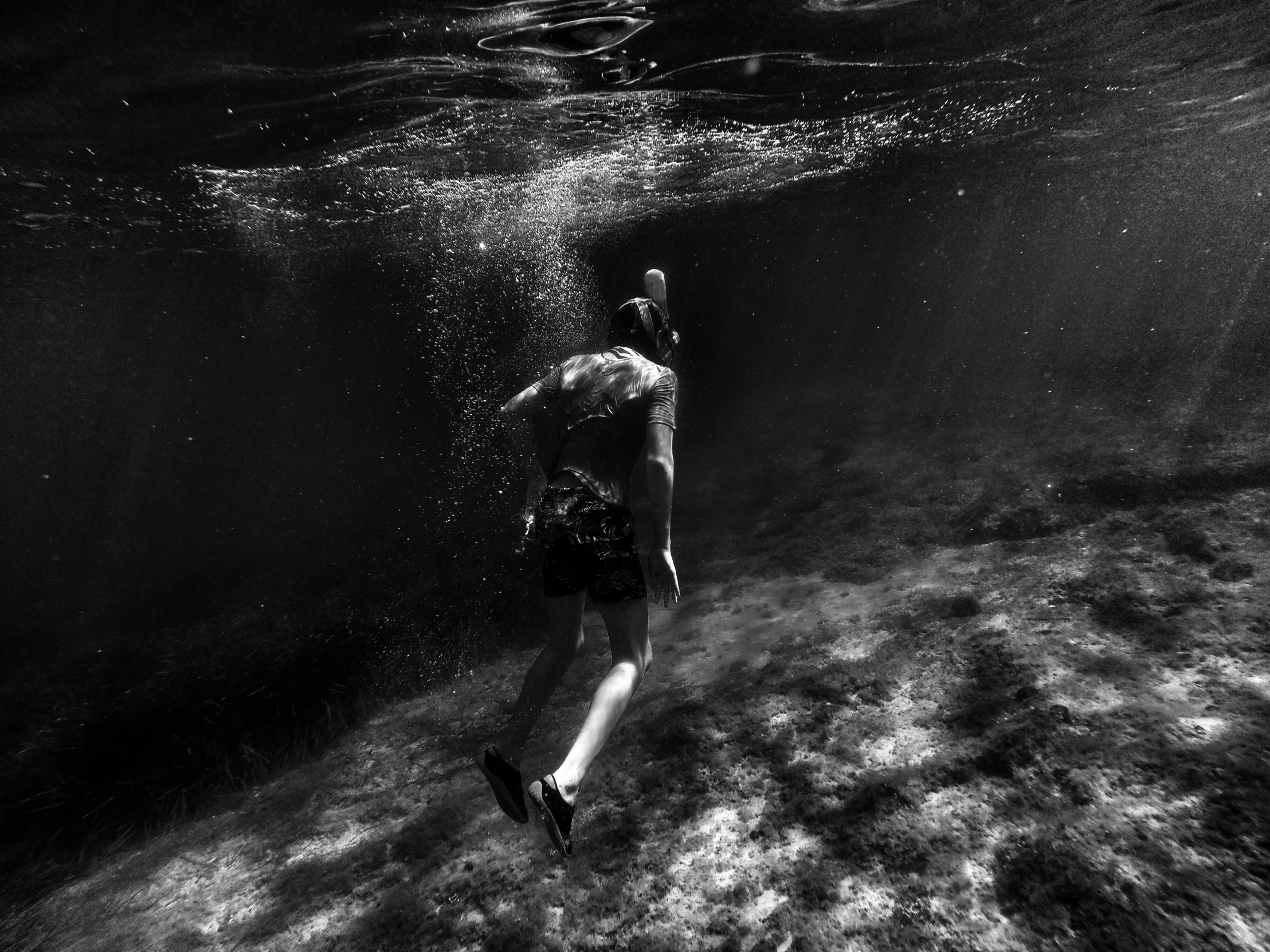 black and white pograph of a man underwater