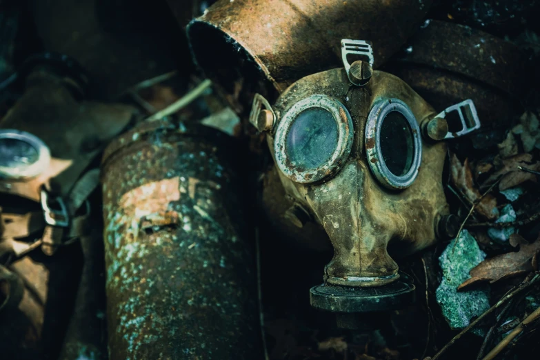 an old, rusty gas mask is in the woods