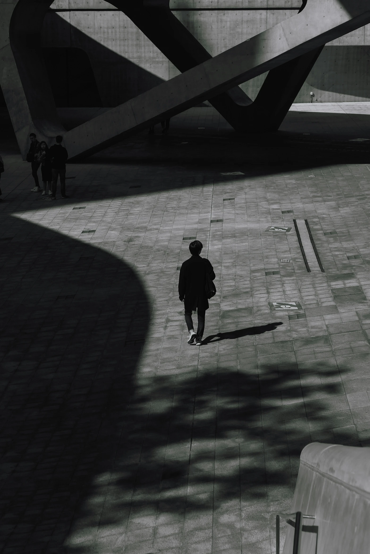 a black and white po of a person walking down a road