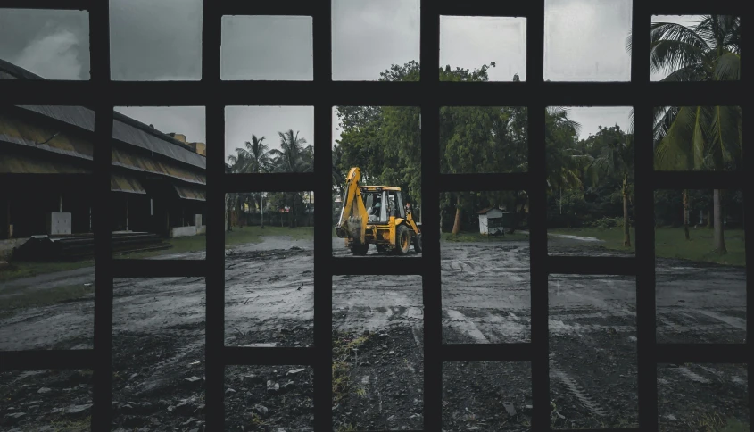 an construction vehicle parked in the middle of a muddy road