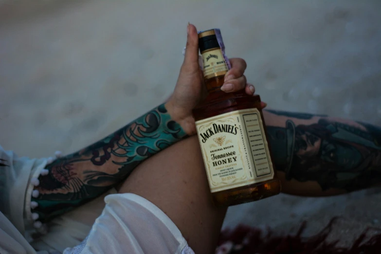 a man holding a bottle of liquor up to the camera