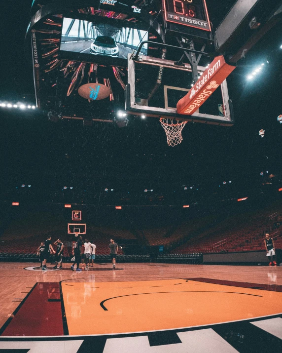 an indoor basketball court has been lit by a crowd