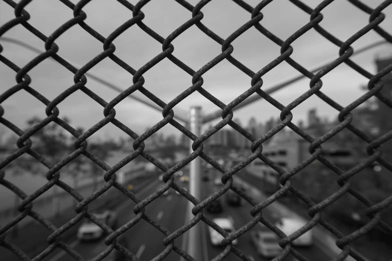 looking down from a bridge towards traffic on the street