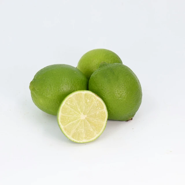 a group of limes on a white surface