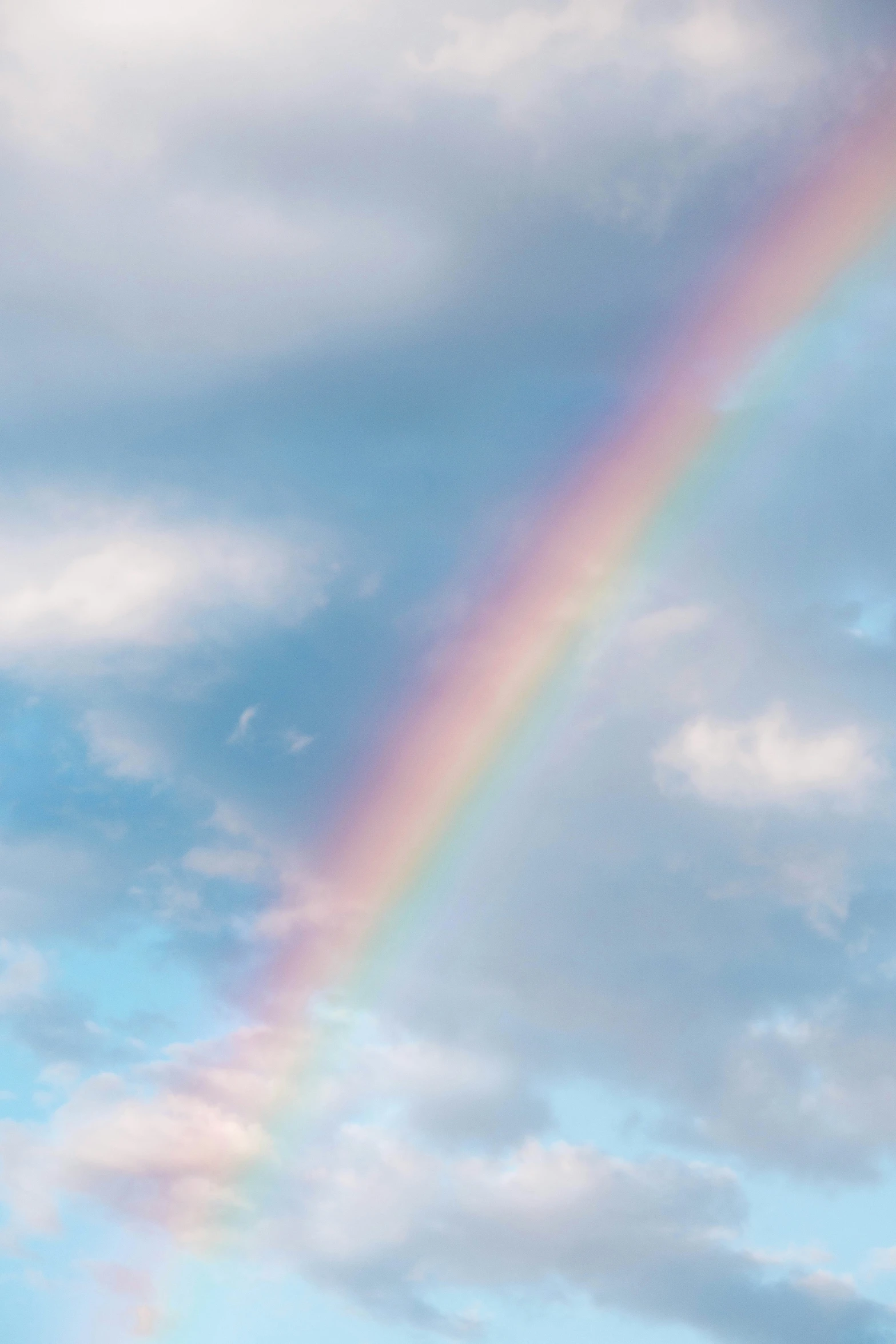 a rainbow that is flying through the sky