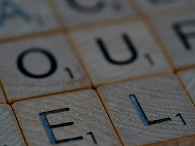 close up of a wooden crossword with the words hello