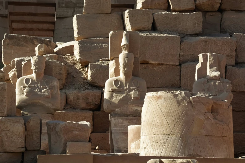 a large group of rocks and statues next to each other