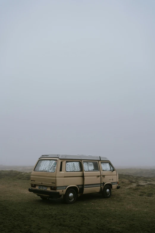 an old bus parked on a field with no passengers