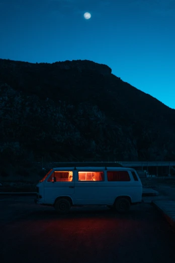 a van is parked in front of a mountain