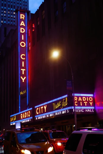 cars driving in front of radio city theater