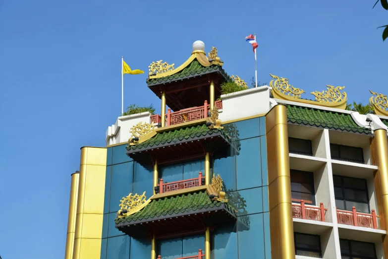 some gold decorations and green roof on a building
