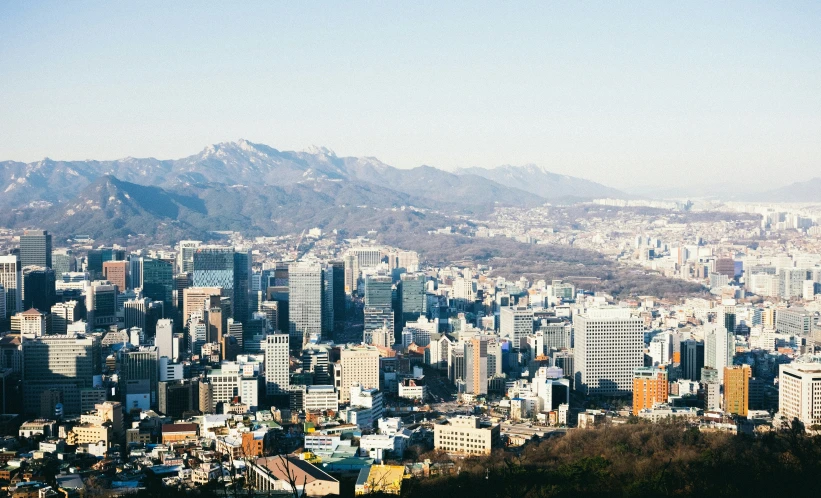 a city with very tall buildings overlooking the mountains