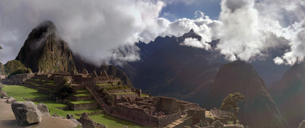 some very tall ruins by a mountain range