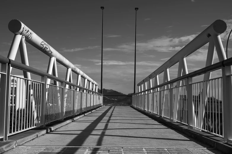 black and white image of a bridge in an industrial city