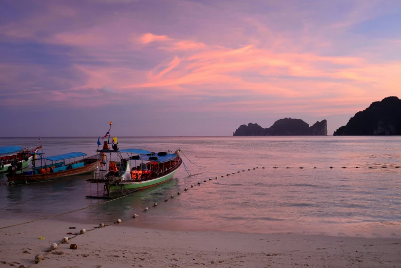 a couple of boats sitting on top of a beach