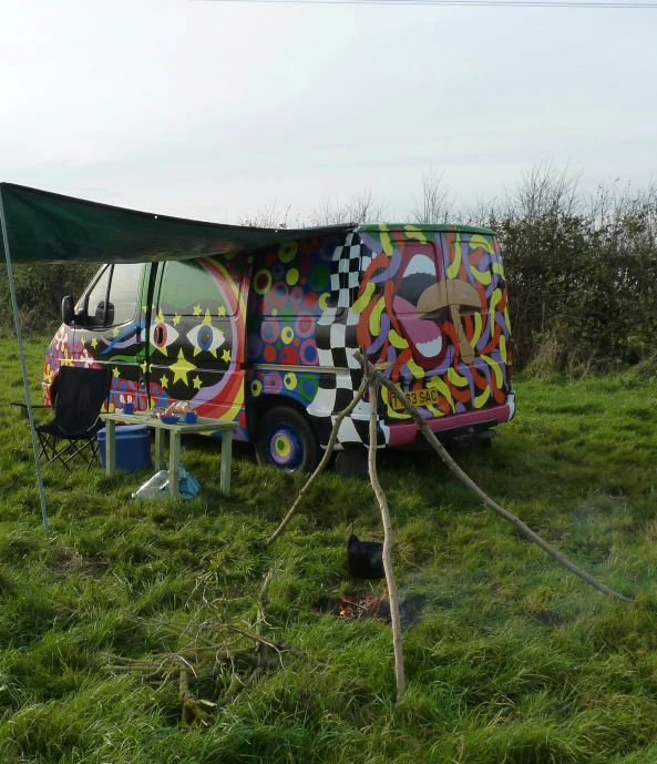 an arty van in a field painted with different colors