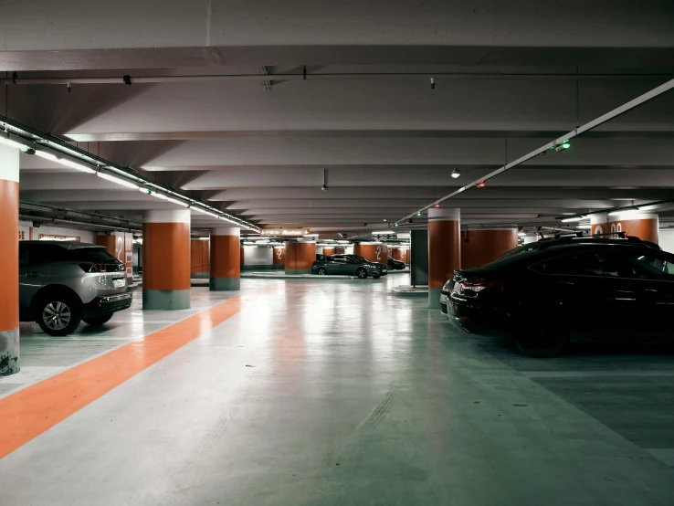 an empty garage with several cars parked