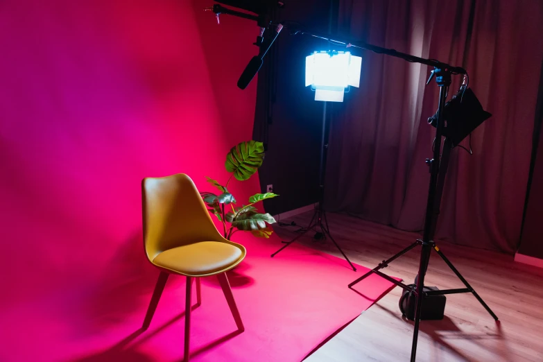 some lights and chairs in a pink room