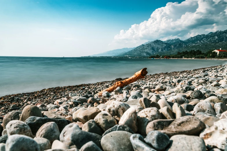 this po shows rocks on a beach and water