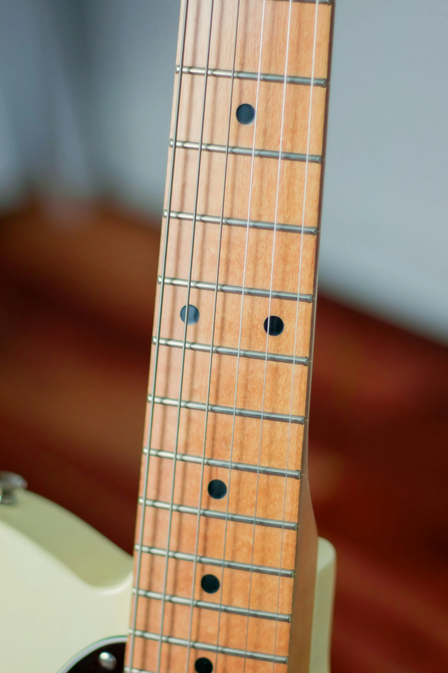 a bass guitar sitting on top of a wooden table