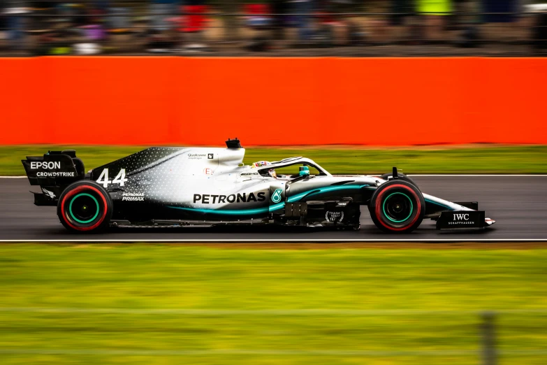 the driver drives a car in front of a crowd