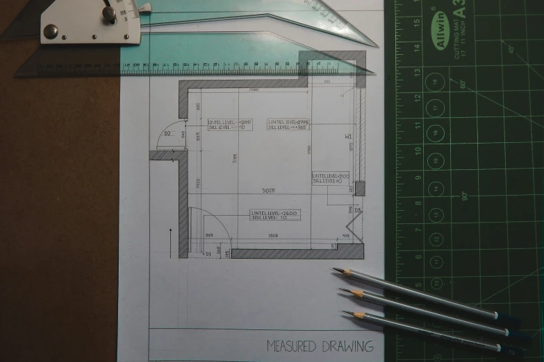 the design drawing shows a room with measurements, and a ruler