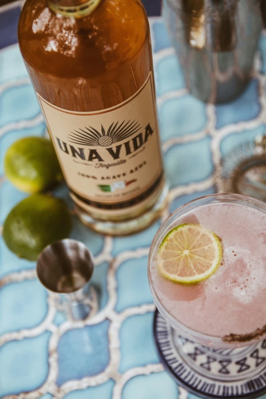 an alcoholic drink, next to a margarita on a table