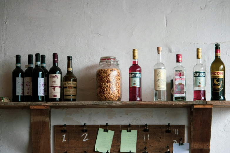 a table with bottles and spice jars, a cork board, and a calendar