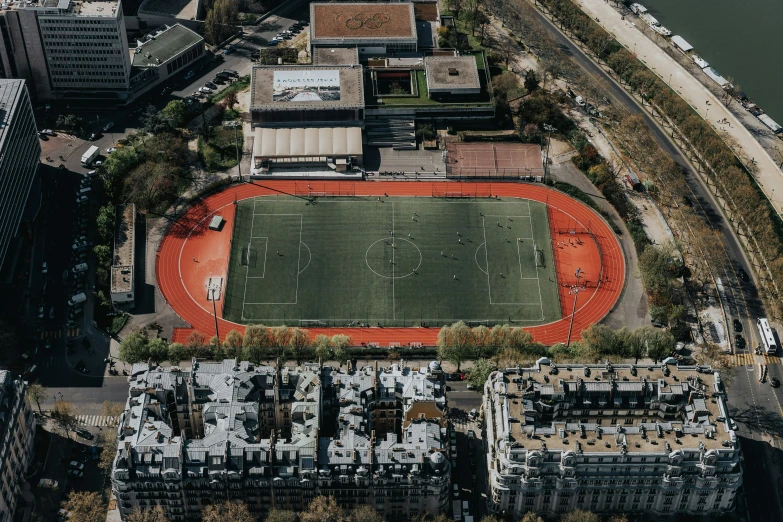 an aerial po of a football field in the middle of the city