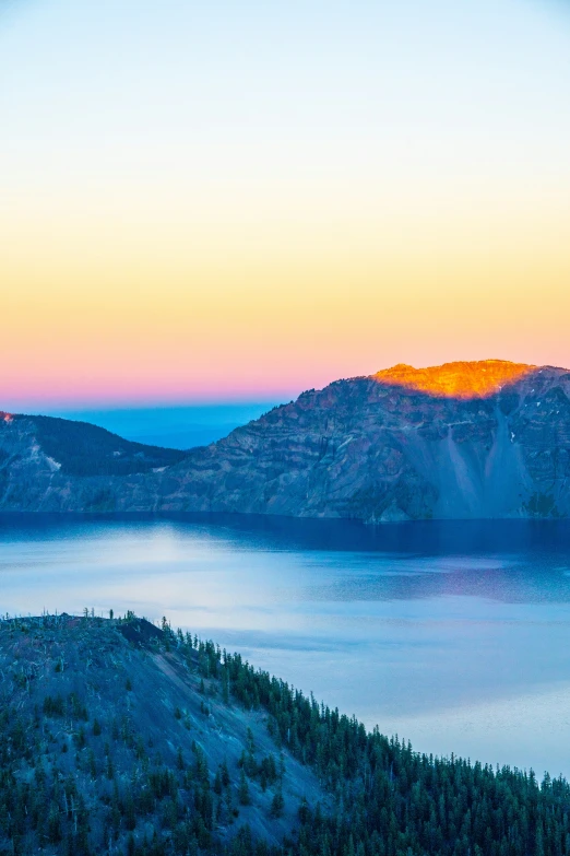 two mountains side by side with a sky view of the water